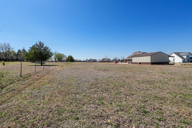 View of yard with an outbuilding and a pole buildi