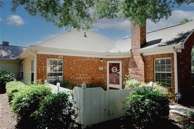 View of front facade featuring brick siding, and a patio