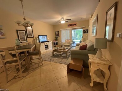 Living room with light tile patterned flooring, a chandelier, and a ceiling fan