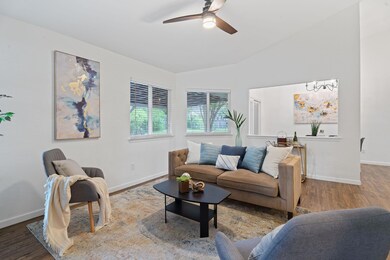 Living area with vaulted ceiling, ceiling fan, ba