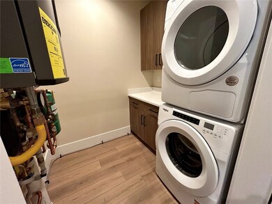 Laundry area with stacked washing machine and drye