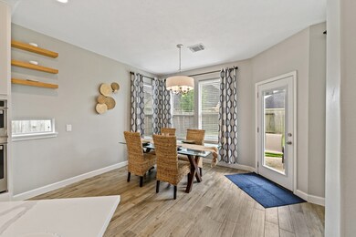 This cozy breakfast nook with updated lighting will be the venue of many merry morning memories!  Framed beautifully by these large windows to your backyard.