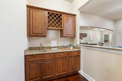 Bar area featuring arched walkways, light stone c