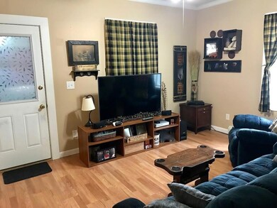 Unit 1 Living Room - Door to...