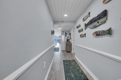 Hallway with attic access, light wood-style floors, recessed lighting, wood ceiling, and baseboards