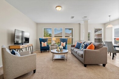 Family room with large windows making the room bri
