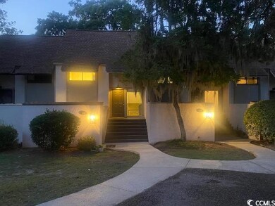 View of front of home featuring roof with shingles and stucco siding