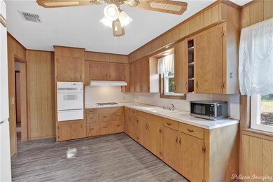 Refrigerator and microwave remain.