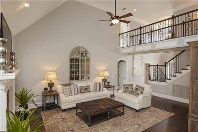 Soaring ceilings in the vaulted living room surrou