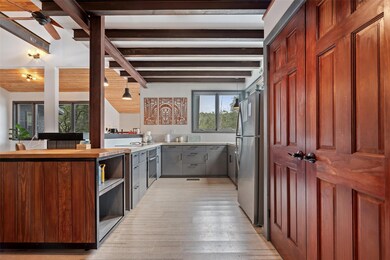 Kitchen featuring lofted ceiling with beams, a pe