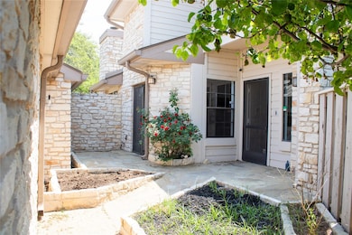 Entrance to property featuring stone siding