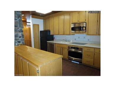 Kitchen view with corian counters,hardwood serving