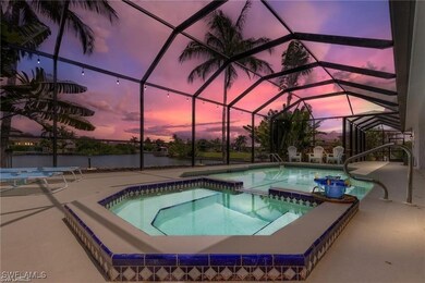 Pool at dusk featuring a pool with connected hot t