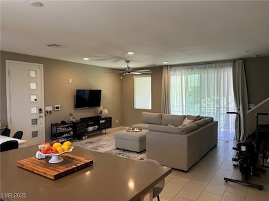 Living area featuring ceiling fan, recessed lighti