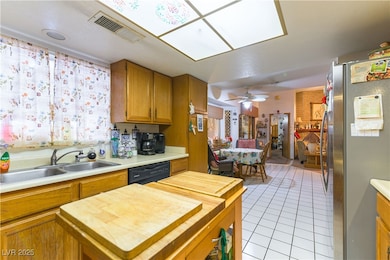Kitchen featuring freestanding refrigerator, woode