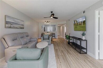 Living room with light wood-type flooring and ceil