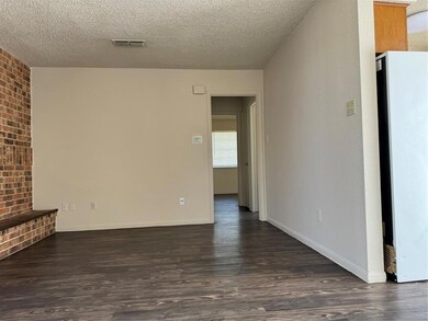 Unfurnished living room featuring dark wood finis