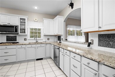 Lovely white cabinetry with opening to great room.
