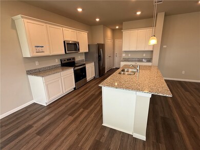Kitchen featuring white cabinetry, stainless steel