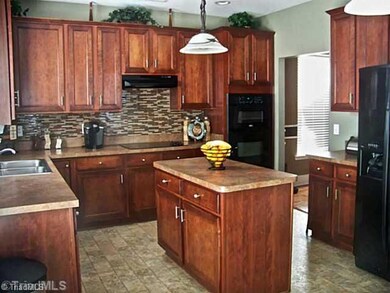Kitchen. To die for kitchen with mosaic tile backsplash, island, and built in appliances! (Not shown is breakfast nook.)