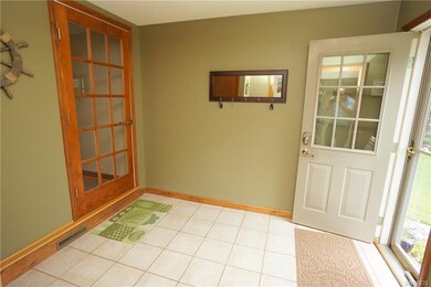 Mudroom with laundry room on first floor. Ceramic 