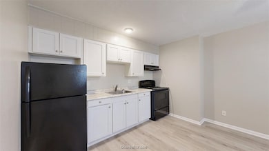 Kitchen with light wood-type flooring, under cabin