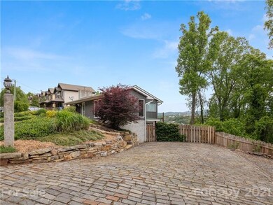 Large cobblestone driveway has plenty of off-street parking.