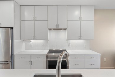 Kitchen with white cabinets, decorative backsplas