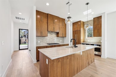 Kitchen featuring visible vents, a sink, gas cook