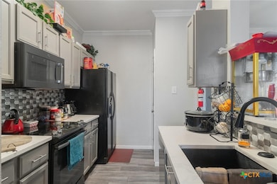 Kitchen with decorative backsplash, stainless stee