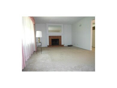 Formal living room with brick fireplace (Hardwoods