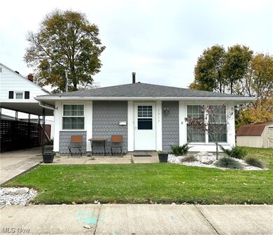 View of front of home featuring a front yard and a carport