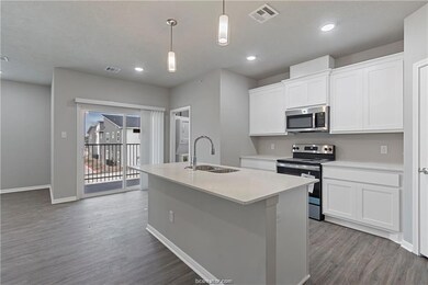 Kitchen with pendant lighting, a center island wit