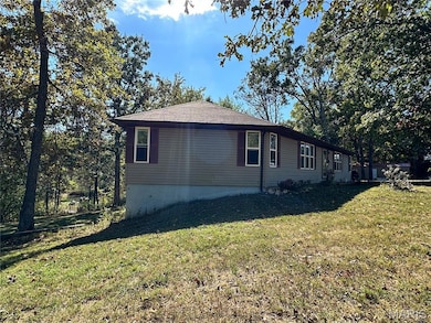 View of home's exterior with a yard