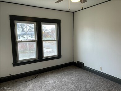 Carpeted empty room with ceiling fan