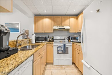 Kitchen featuring sink, a paneled ceiling, white a