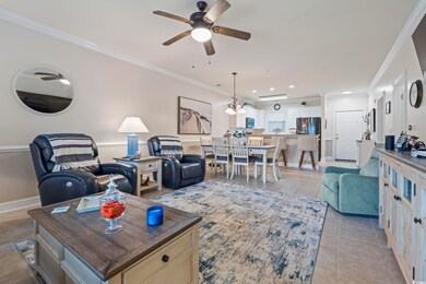 Living room with crown molding, ceiling fan, light tile patterned floors, and recessed lighting