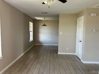 Empty room with wood tiled floors and a ceiling fan