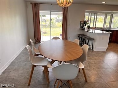 Tiled dining room with a wealth of natural light