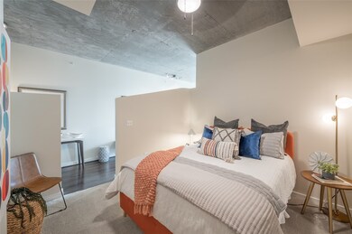 Primary bedroom loft featuring sweeping high ceilings and a mirrored closet!