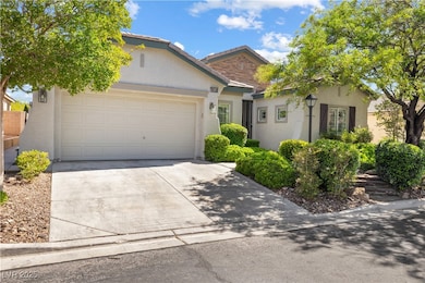 View of front of home with stucco siding, driveway