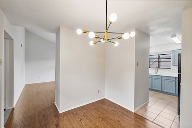 Unfurnished dining area with light wood-type flooring and a chandelier