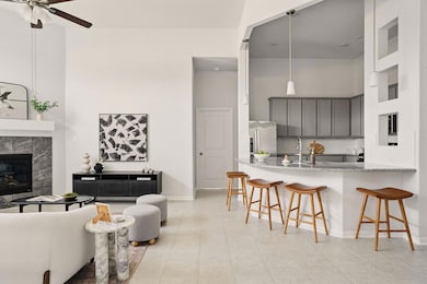 Living room featuring ceiling fan, a towering cei