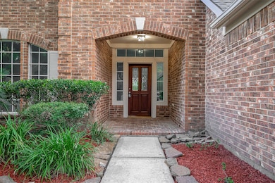 Inviting covered entry with red mulch accents and