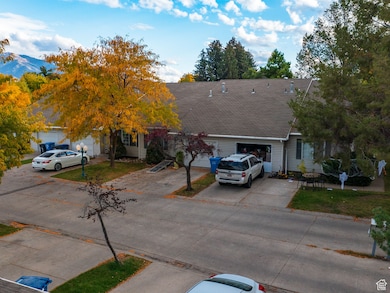 View of front of property with driveway, a front lawn, and a shingled roof