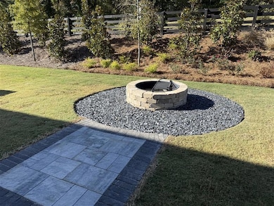 View of yard with a patio area and an outdoor fire pit