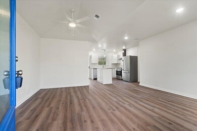 Unfurnished living room with ceiling fan, dark woo