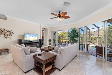 Living room featuring ceiling fan, a healthy amount of sunlight, and ornamental molding