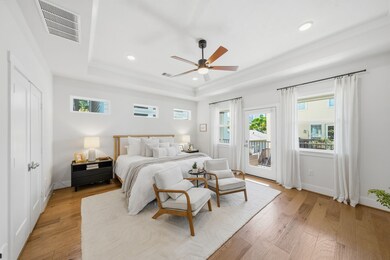 Stunning primary suite with a private balcony and lots of windows. Don't miss the downtown view!