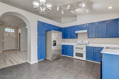 Kitchen featuring stainless steel fridge, arched w